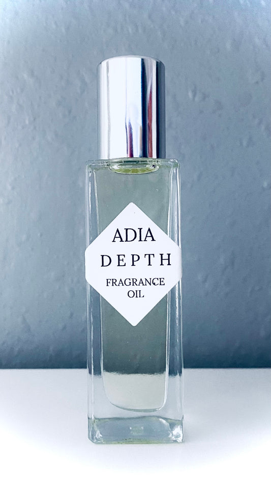 Travel-friendly natural fragrance oil in a square shaped roll-on bottle, made with light amber and a clean, masculine essential oil blend.