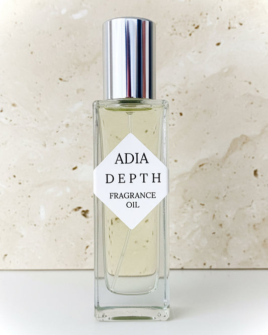Travel-friendly natural fragrance oil in a square shaped roll-on bottle, made with light amber and a clean, masculine essential oil blend.